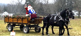 Santa riding on a horse drawn carriage